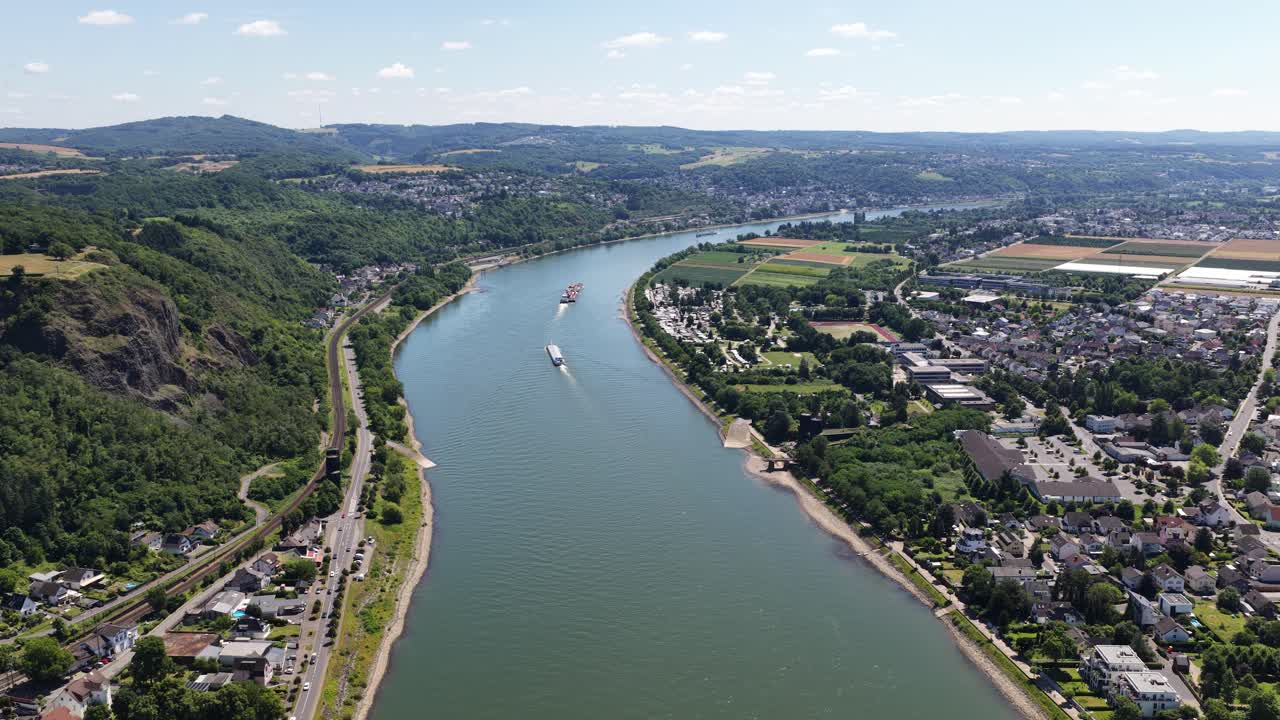 Rhine river at Remagen, shipping over the river. Vessels, transport, industrial shipping. Aerial video