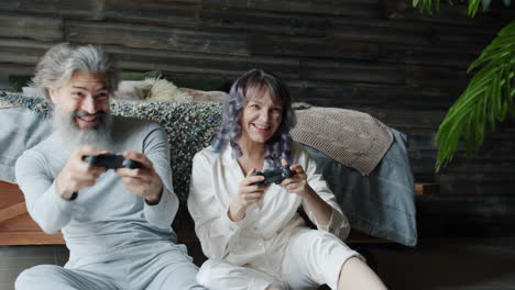 happy couple playing video games at home