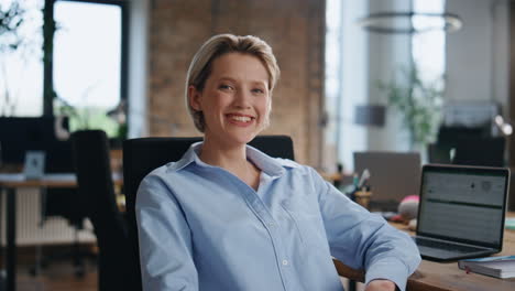 successful woman boss posing in corporate office close up. lady looking camera