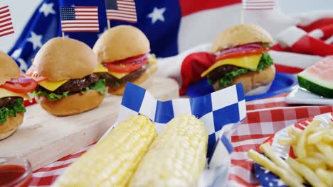 hamburgers and french fries served on table with 4th july theme