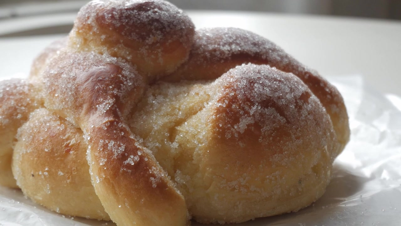 Sweet bread called Bread of the Dead (Pan de Muerto) enjoyed during Day of the Dead festivities in Mexico - light camera move