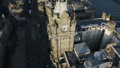 rising aerial view of the balmoral hotel near the waverley train station is edinburgh, scotland