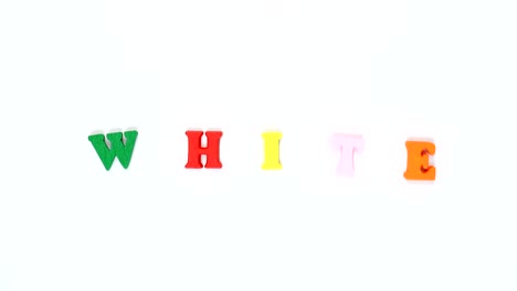 word "white" formed of wooden multicolored letters. colorful words loop.