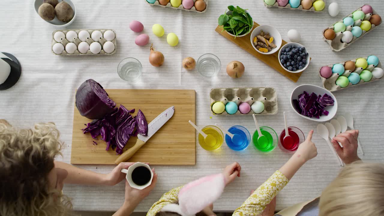 Top view of family prepare natural dyes for coloring eggs