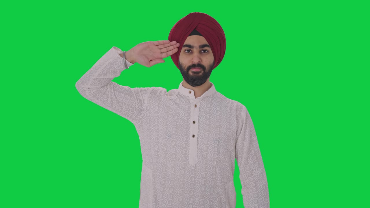 Fiero uomo indiano Sikh che saluta lo schermo verde