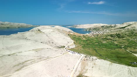 Stark-separation-between-barren-white-land-and-green-valley-with-deep-blue-sea-nd-light-blue-sky