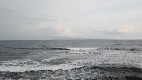 calm waves in bali silver sea, indonesian shore in pacific ocean, quiet peaceful water manifesting tranquility, 60 fps