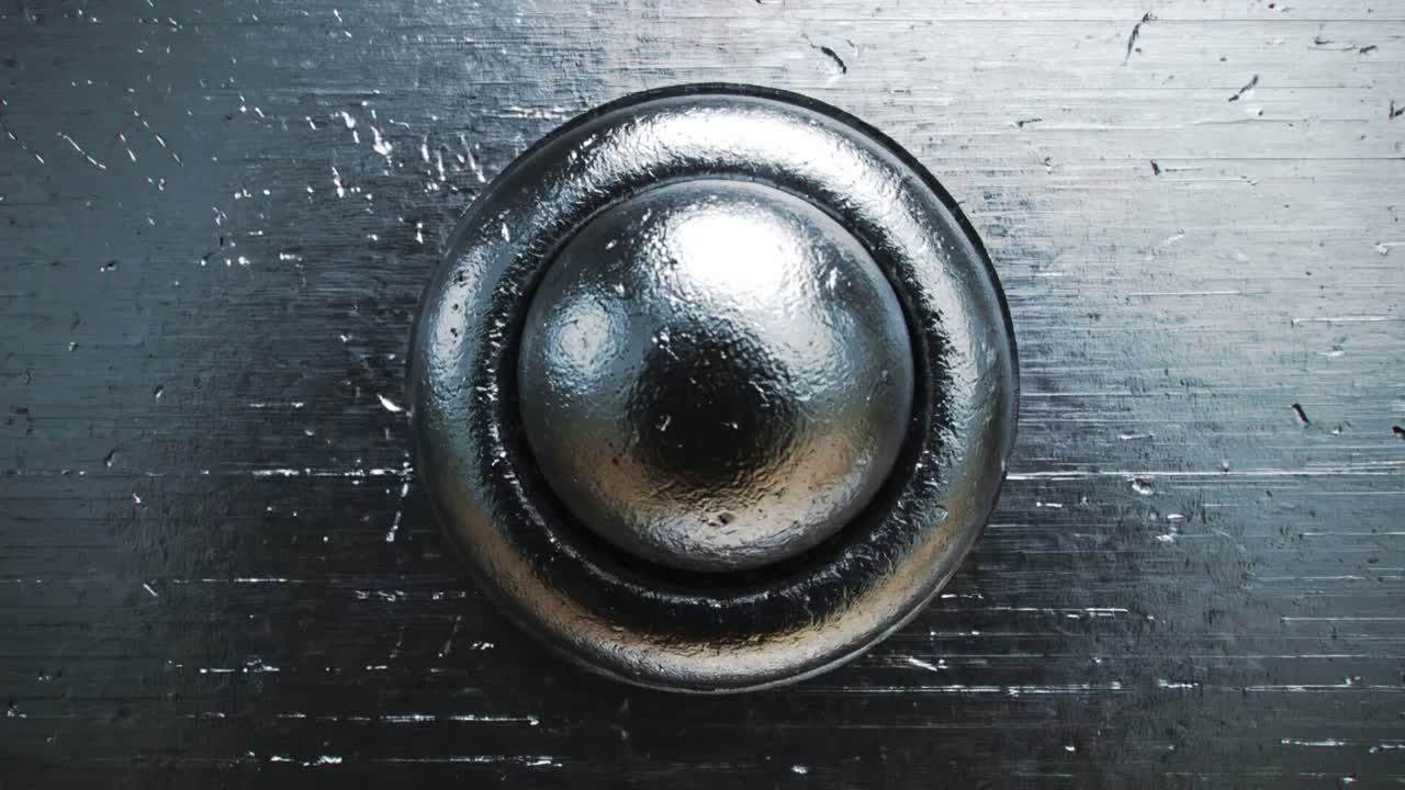 Pulling back camera from close-up, revealing metal shelving bays at warehouse, exposing fasteners