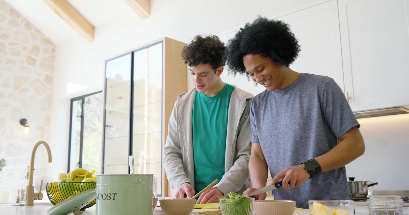 Two Young Men Preparing Healthy Food Together in Modern Kitchen