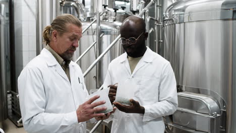 men holding product in container