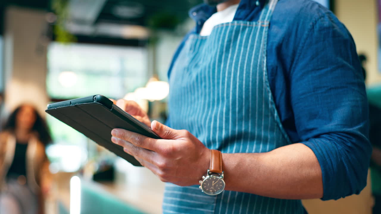 Business owner, hands and tablet for cafe