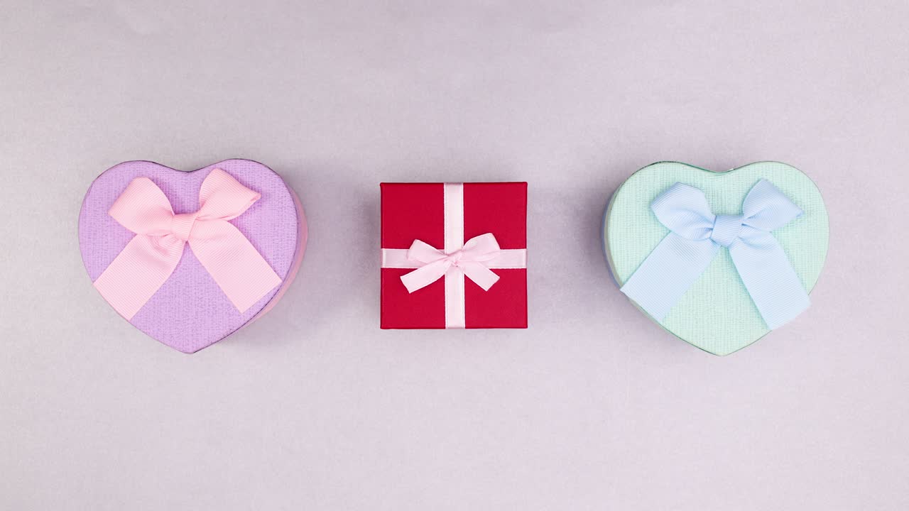 Pink red and blue gifts move in circle. Stop motion