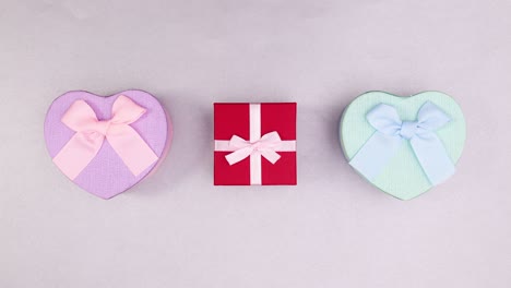 Pink red and blue gifts move in circle. Stop motion