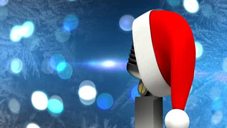 Santa-hat-over-microphone-against-spots-of-light-against-blue-background