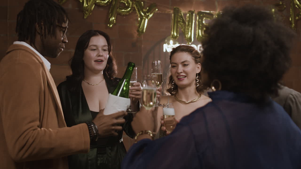 Friends celebrate with champagne at a New Year's Eve party