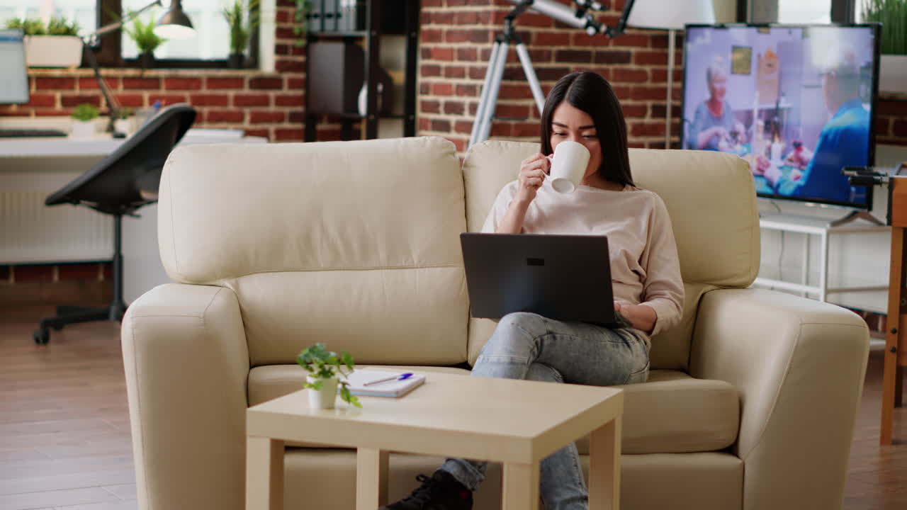 Woman working remotely on laptop at home