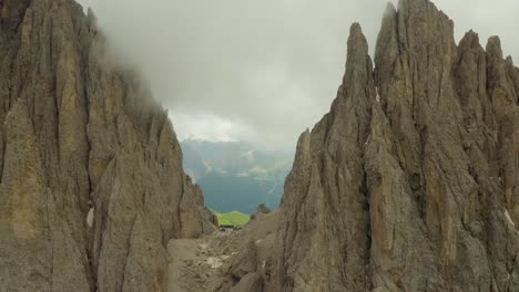 fly between mountain tops covered with rainy clouds, dolomites italy