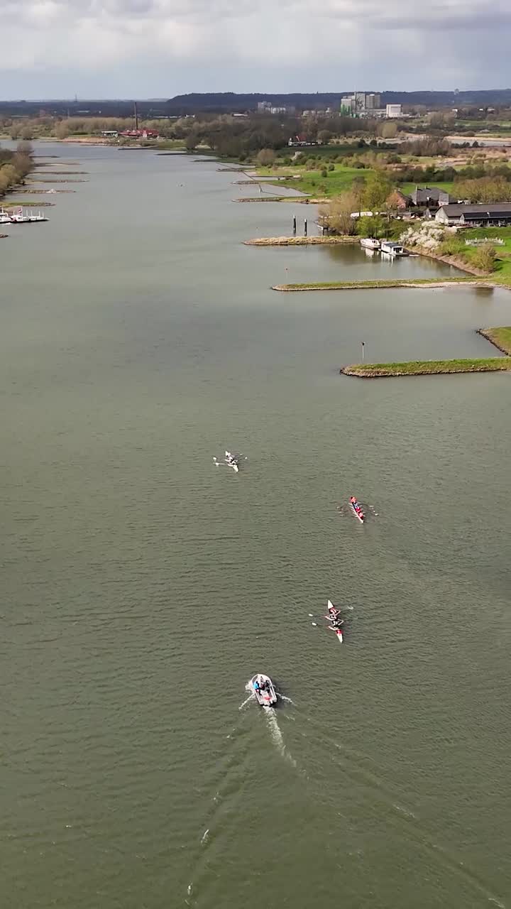 Aerial View of Rowing Boats Training on a Wide River