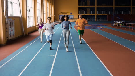 people running in an indoors track