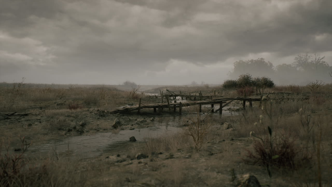 Dry landscape with a wooden bridge under a cloudy sky at dusk