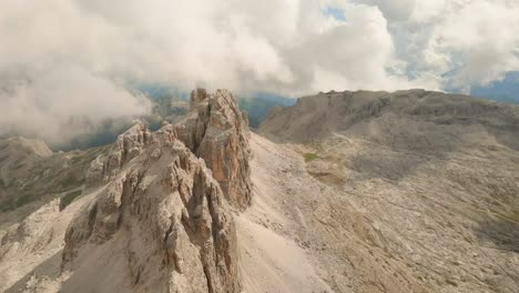 drone descends lagazuoi mountain, italian dolomites, skimming the ridge