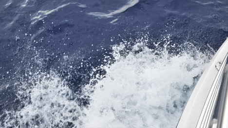 top down view of boat's wake as it moves through deep ocean