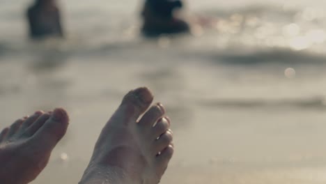 young woman feet with pedicure against blurred ocean closeup