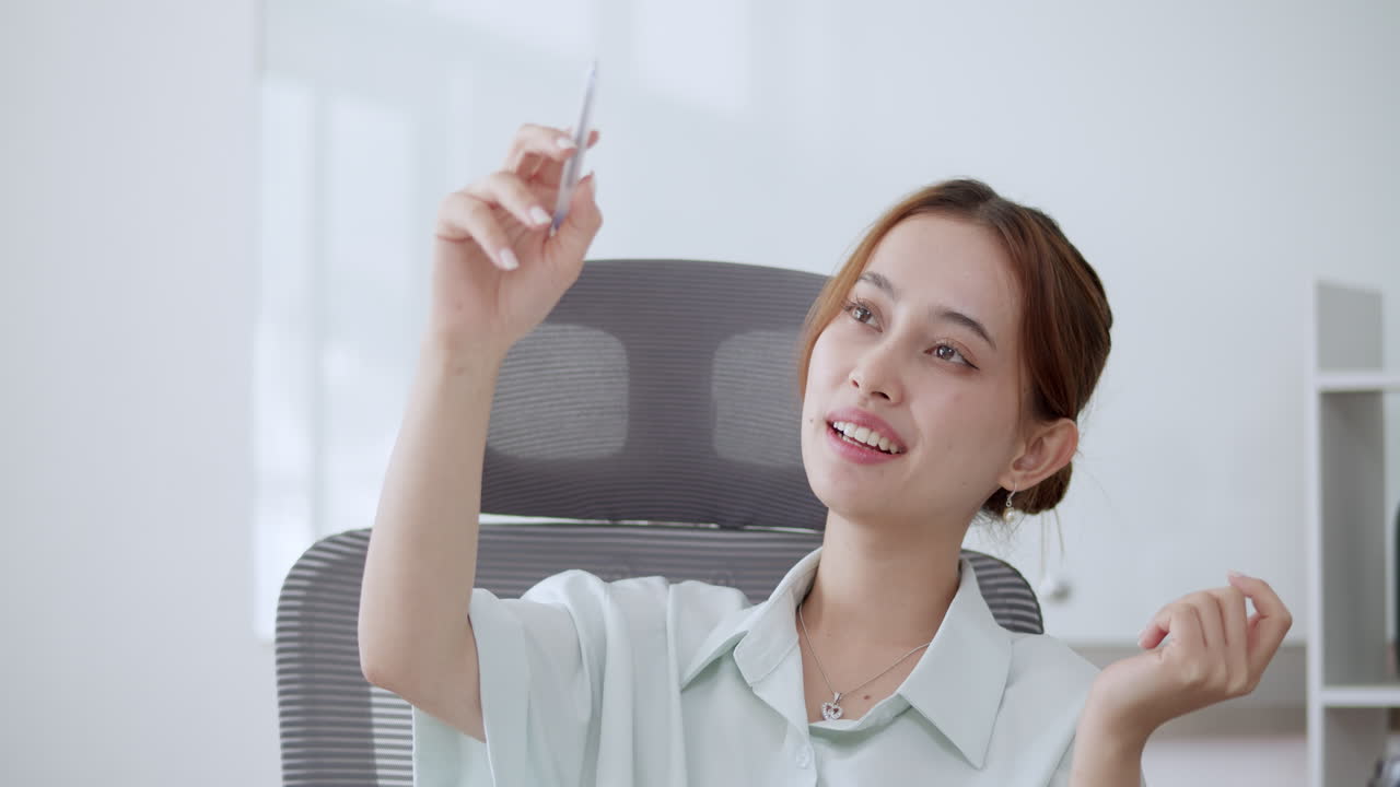 A young career woman making making some motions in the air as she makes her presentation in a meeting.