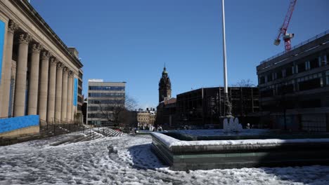 city hall, statues and water features in snow on sunny day, sheffield