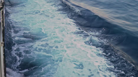 tilt shot of churning waters, made by ferry boat traveling at sea of argosaronikos, greece 120fps