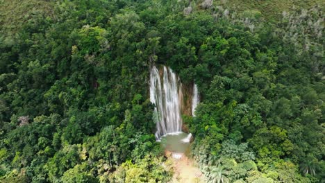 scenic overhead footage of el limón waterfall surrounded by jungle greenery, capturing the beauty of this iconic dominican republic travel destination from above.