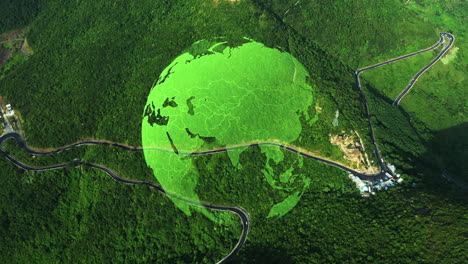 aerial view of a green earth globe over a winding road in a lush forest