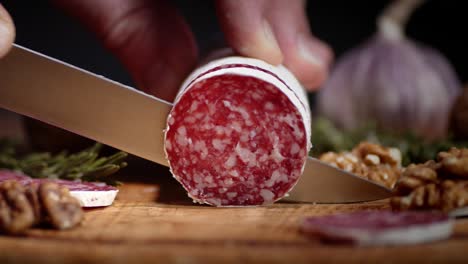 stick of salami cut into pieces with walnuts and rosemary.