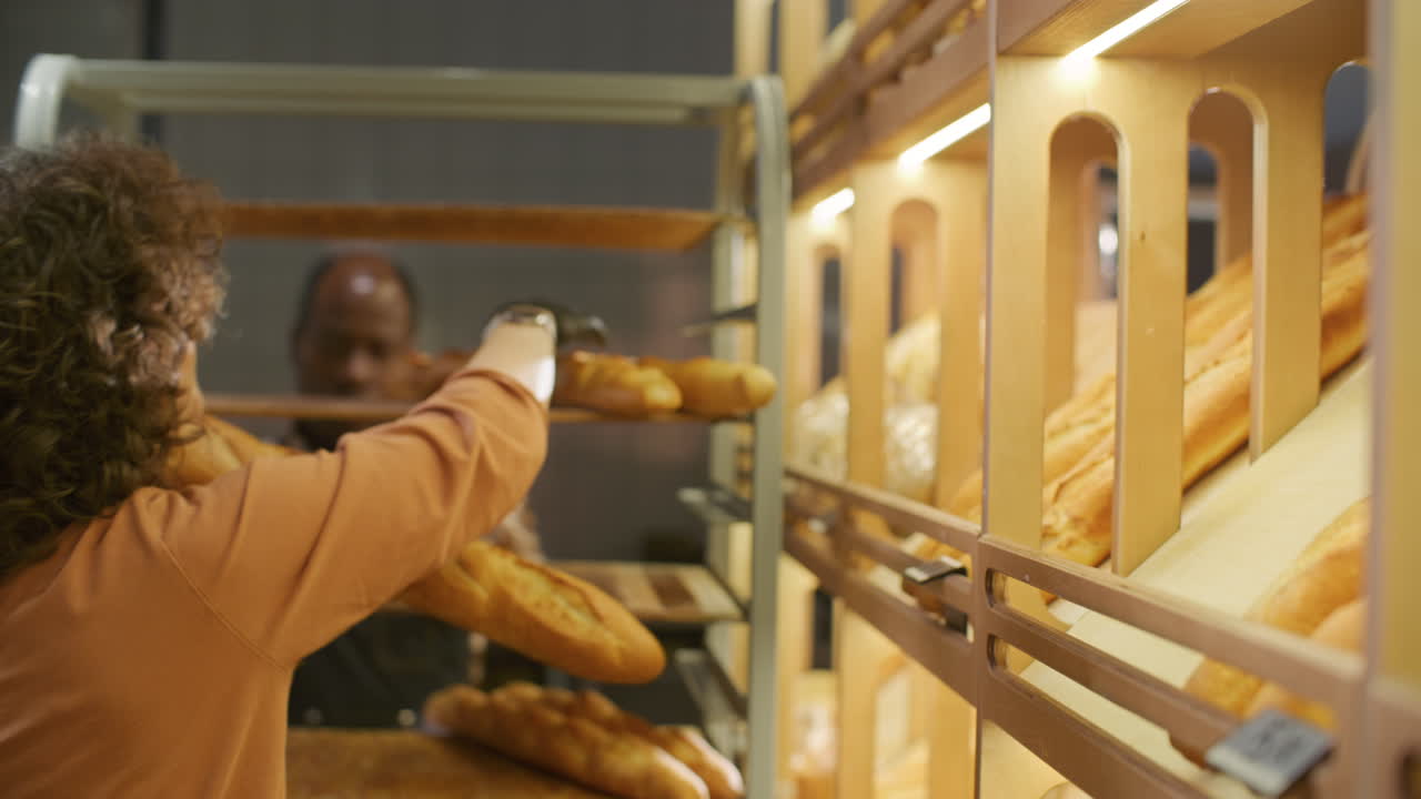 Bakery Employee Arranging Baguettes