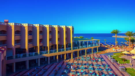 day to night timelapse by the hotel and beach resort on the red sea coast in hurghada, egypt