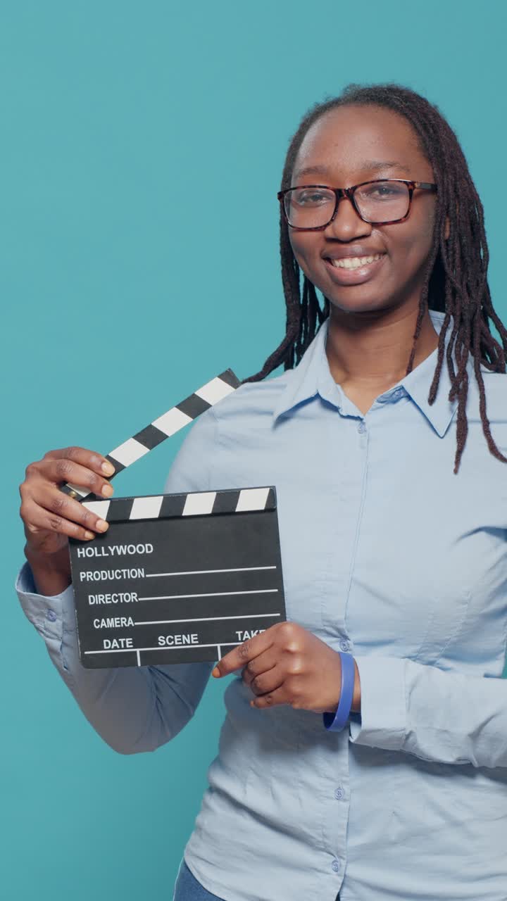 Woman holding a clapperboard