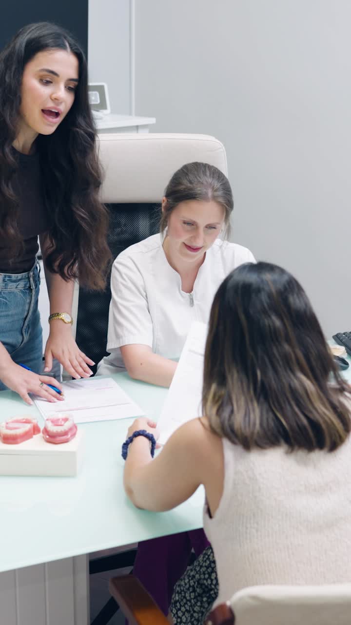 Dentist consulting with patients in the office