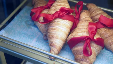 fresh croissants with red ribbons