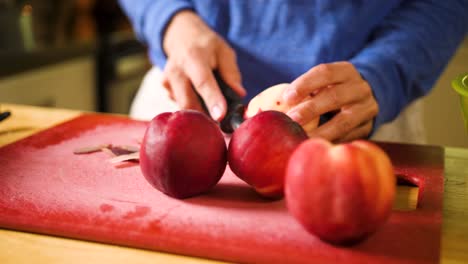 peeling-peaches-for-a-pie-filling-close-up-of-hands