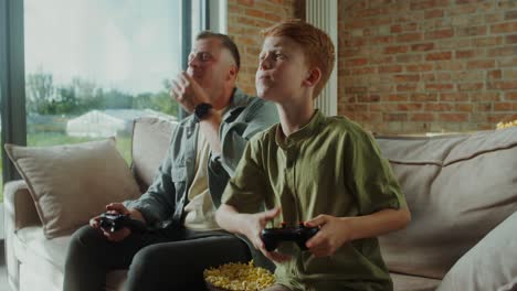 father and son playing video games