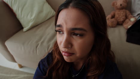 Sad-woman-sitting-on-the-carpet