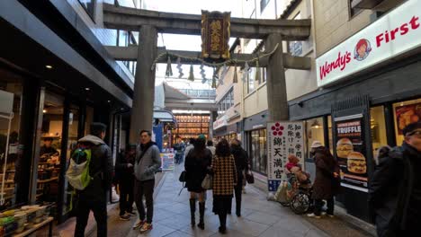 pedestrians walking through a busy shopping arcade