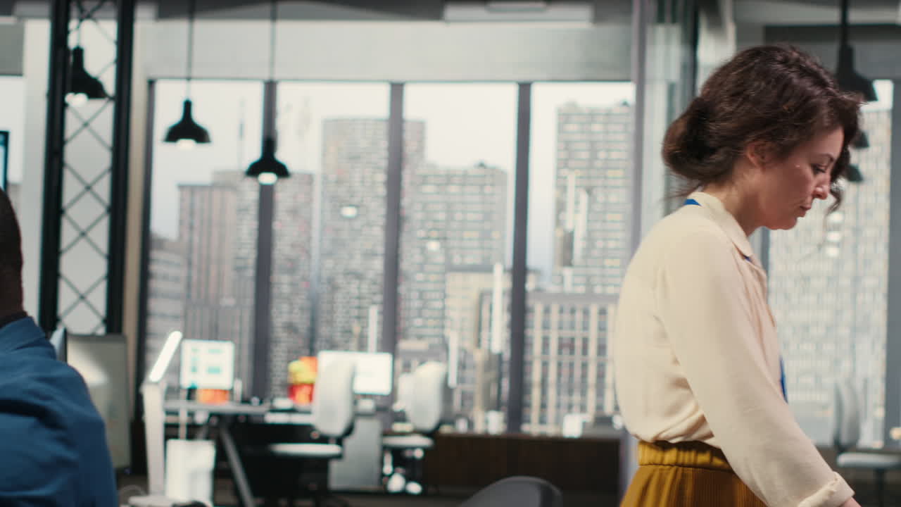 Vertical Video Woman secretary in an office pushes a trolley filled with paperwork