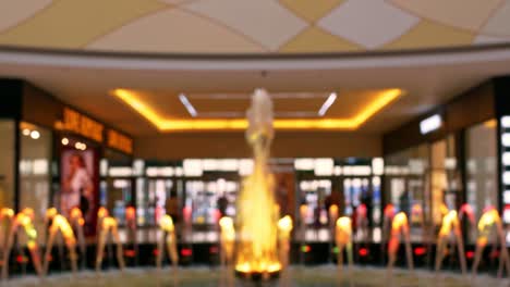 the shopping center is decorated with a dynamic light fountain. the fountain composition attracts buyers with its beautiful appearance. shopping in malls. the blur is not a recognizable place