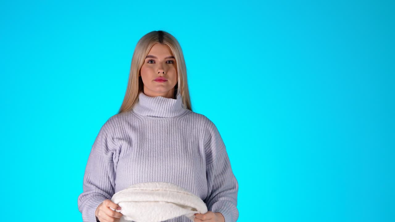 Woman in a White Scarf and Grey Sweater