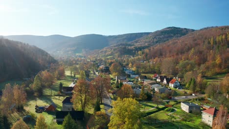 Aerial-drone-shot-of-beautiful-czech-village-in-the-middle-of-Beskydy-mountains-during-sunny-autumn-fall-day