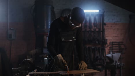 man welding metal in a workshop