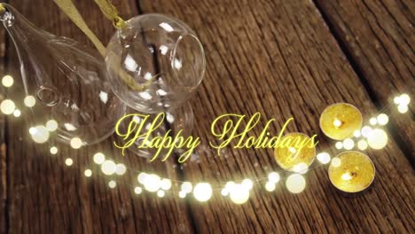 Animation-of-text,-happy-holidays,-in-yellow,-over-string-lights,-marshmallows-and-xmas-decorations
