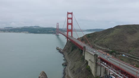 Tilting-aerial-shot-of-San-Francisco's-Golden-Gate-Bridge-on-a-foggy-overcast-day