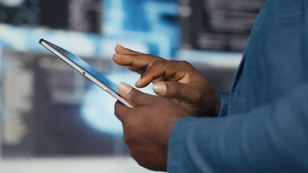 Young professional engineer focused on coding with tablet at an innovation hub
